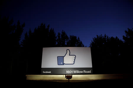 FILE PHOTO: The sun rises behind the entrance sign to the Facebook headquarters in Menlo Park before the company's IPO launch, May 18, 2012. REUTERS/Beck Diefenbach/File Photo