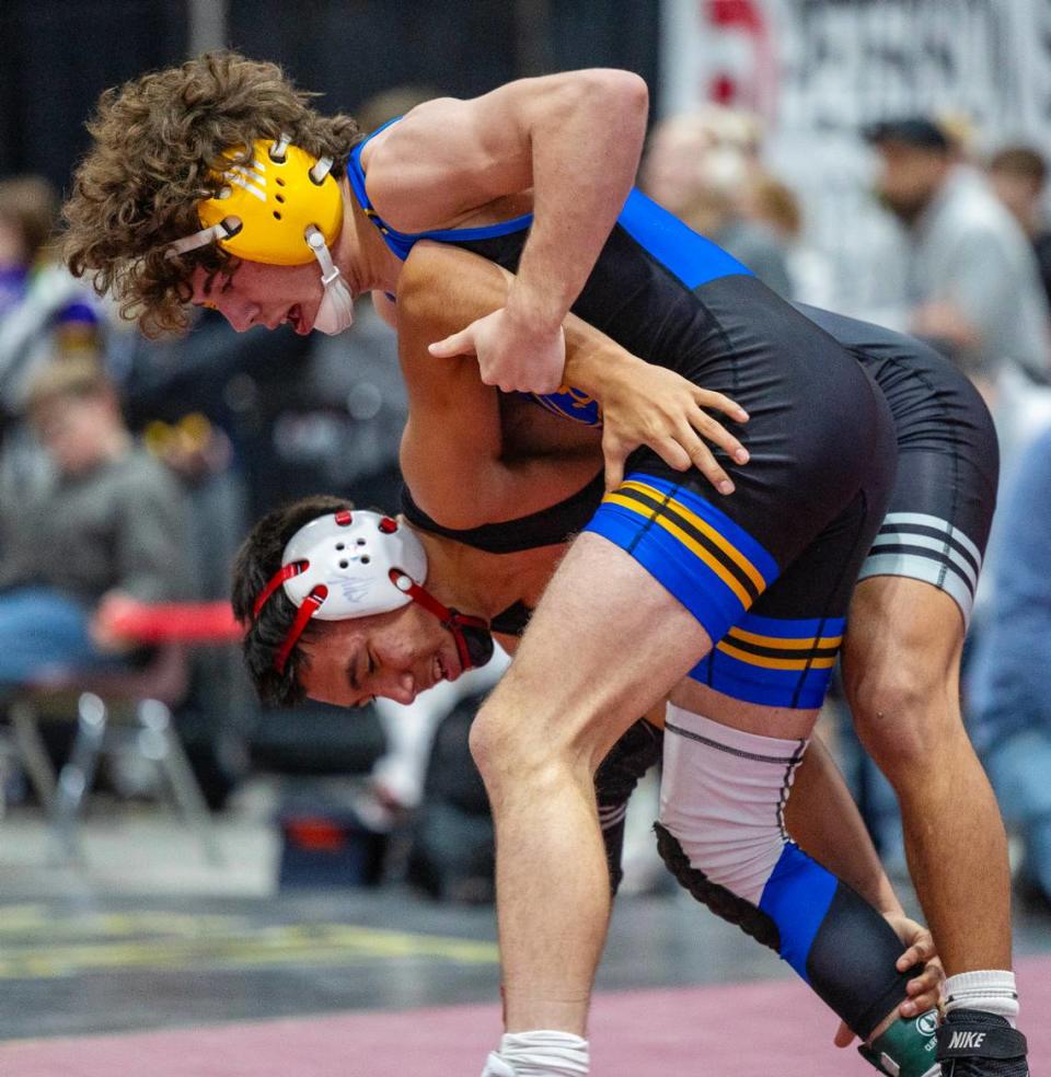 Caldwell’s Jaxson Freeman, top, and Nampa’s Vincent Contreras, bottom, compete in the 113-pound championship at the Rollie Lane Invitational on Jan. 6 at the Ford Idaho Center in Nampa.