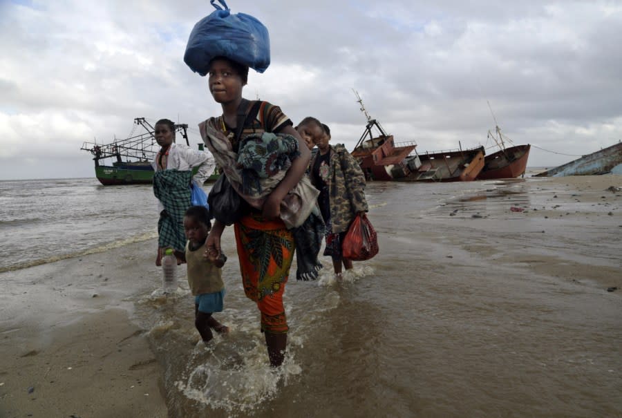 Displaced families arrive after being rescued by boat from a flooded area of Buzi district, 200 kilometers (120 miles) outside Beira, Mozambique, Saturday, March 23, 2019. (AP Photo/Tsvangirayi Mukwazhi, File)