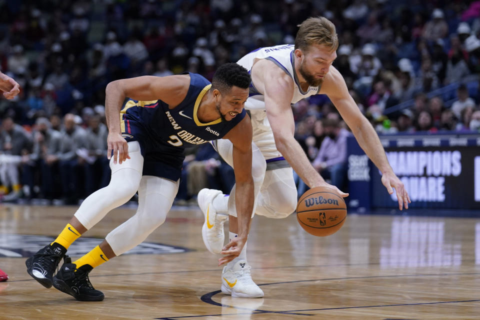 New Orleans Pelicans guard CJ McCollum (3) chases a loose ball against Sacramento Kings forward Domantas Sabonis in the second half of an NBA basketball game in New Orleans, Wednesday, March 2, 2022. The Pelicans won 125-95. (AP Photo/Gerald Herbert)