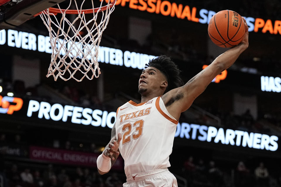 Texas forward Dillon Mitchell dunks on a fast break during the first half of an NCAA college basketball game against LSU, Saturday, Dec. 16, 2023, in Houston. (AP Photo/Kevin M. Cox)