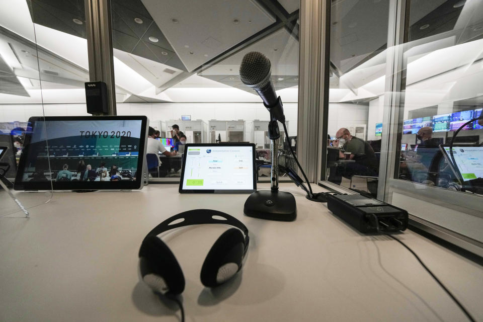 A console of interpreters at the main press center, at the 2020 Summer Olympics, Friday, July 30, 2021, in Tokyo, Japan. Unlike previous Olympics, all the interpretation is being done remotely with most interpreters working in booths at the main center. Their simultaneous translation can be accessed at all Olympic venues on an app. This eliminates interpreters getting tied up in traffic heading to an venue. (AP Photo/Luca Bruno)