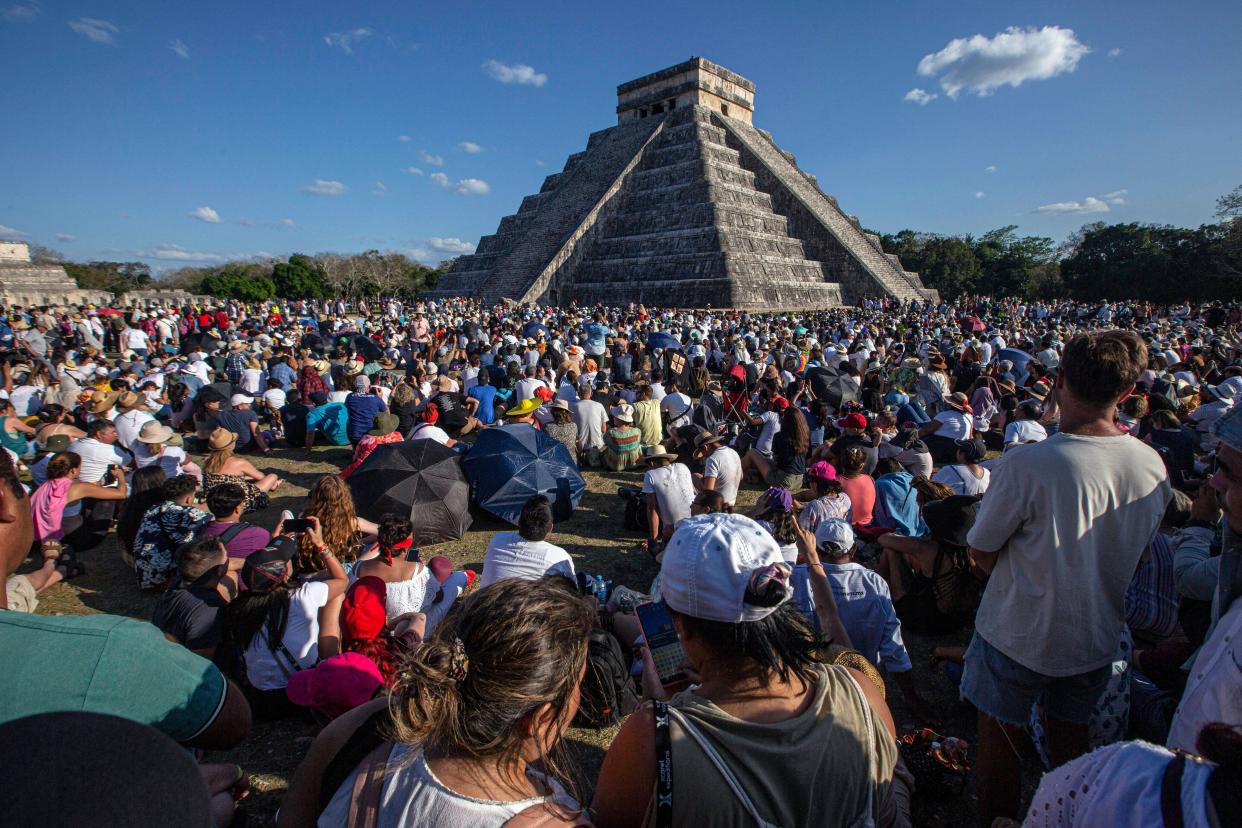 People surround the Kukulcan Pyramid at the Mayan archaeological site of Chichén Itzá in Yucatan state of Mexico during the celebration of the spring equinox on March 21, 2023.