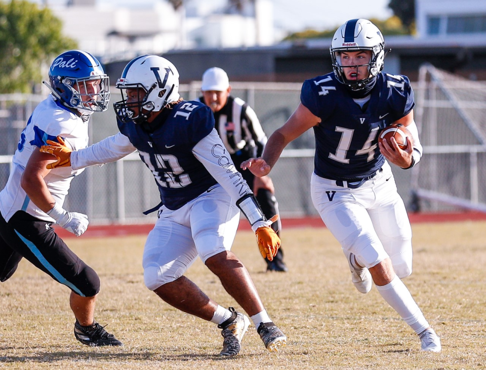 Venice quarterback Sam Vaulton, right, runs with the ball during Venice's victory over Palisades.