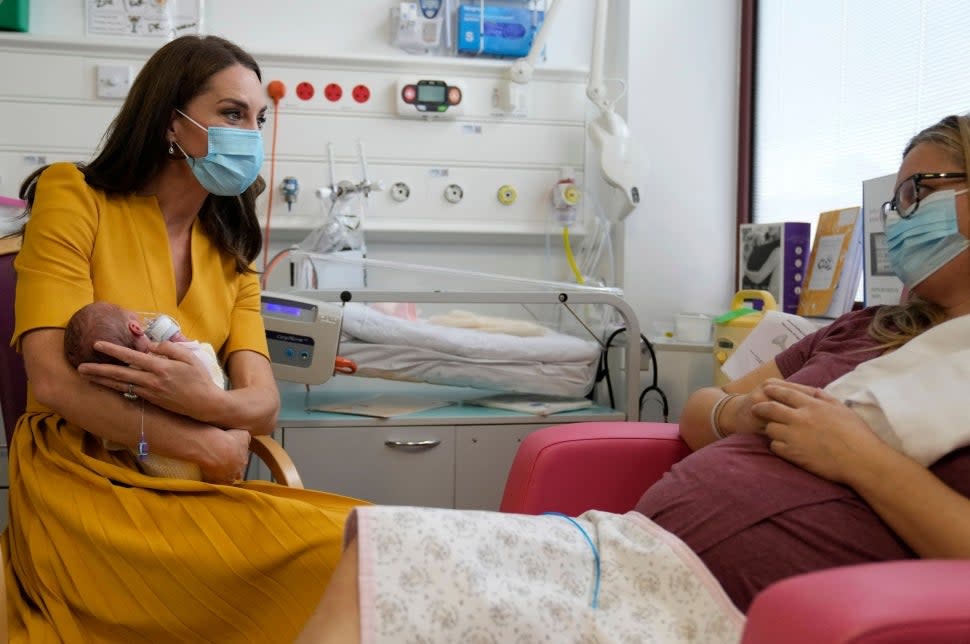 Kate Middleton holds baby during visit to the hospital 