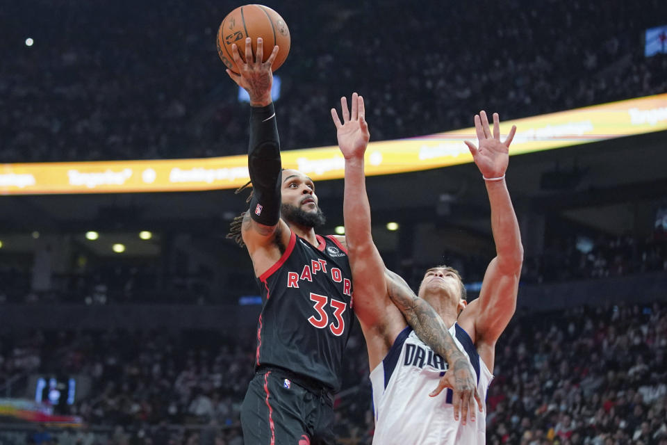 Toronto Raptors guard Gary Trent Jr. (33) shoots over Dallas Mavericks center Dwight Powell (7) during the first half of an NBA basketball game Saturday, Oct. 23, 2021, in Toronto. (Evan Buhler/The Canadian Press via AP)