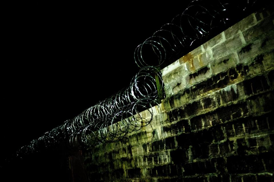 Barbed wire still surrounds the entire property during a paranormal flashlight tour of Brushy Mountain State Penitentiary in Petros, Tennessee.