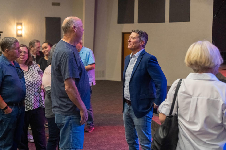Rep. Ronny Jackson meets with a constituent at a town hall Tuesday at the Arena of Church in Amarillo.