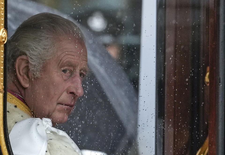 FILE- Britain's King Charles III makes his way to Westminster Abbey prior to his coronation ceremony in London Saturday, May 6, 2023. A year after the death of Queen Elizabeth II triggered questions about the future of the British monarchy, King Charles III’s reign has been marked more by continuity than transformation, by changes in style rather than substance. (AP Photo/Alessandra Tarantino, File)