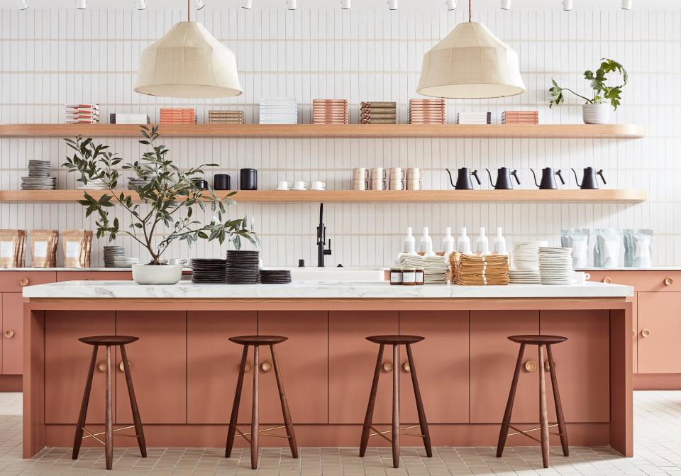 Custom counter stools by Oja Design—a local, San Francisco-based woodworker—pair with the kitchen’s dusty peach cabinetry, which is painted in Benjamin Moore’s Fox Run. The pendants are by the Future Perfect.