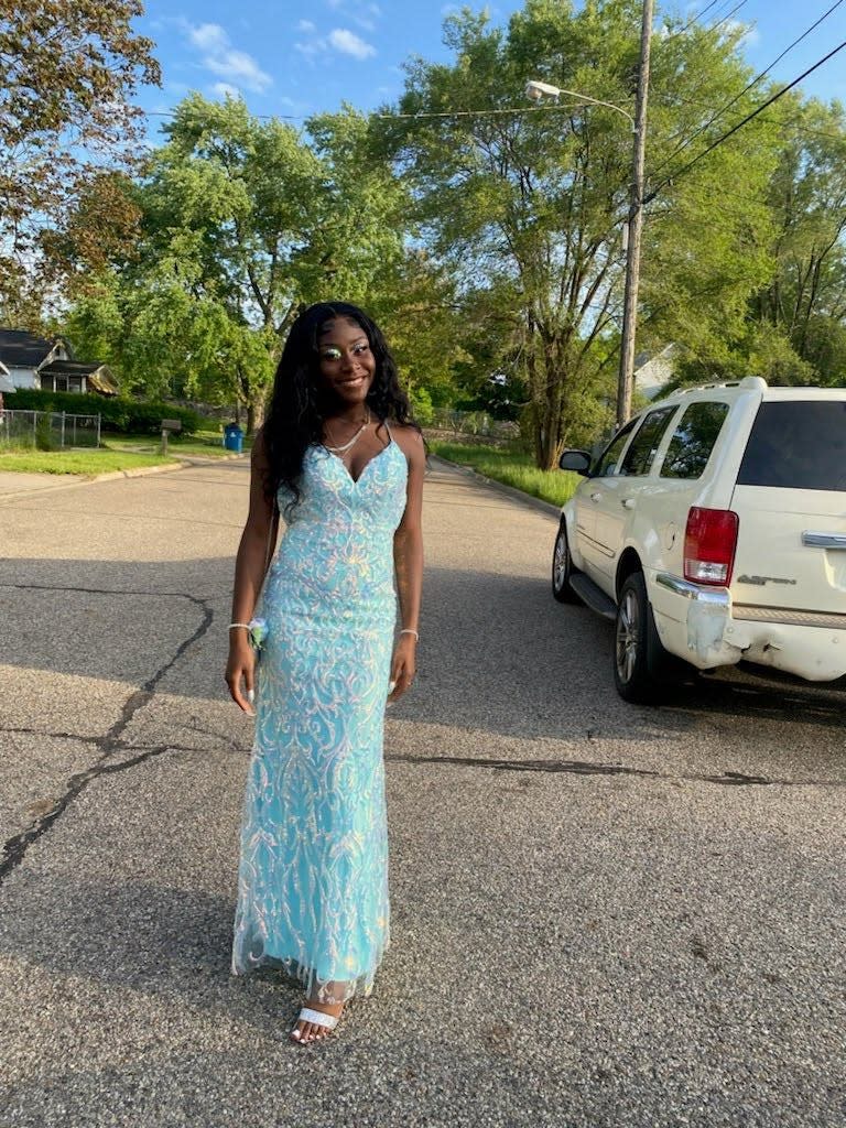 Jamaria Price, a senior at Lakeview Alternative High School, poses for a picture in her prom dress.