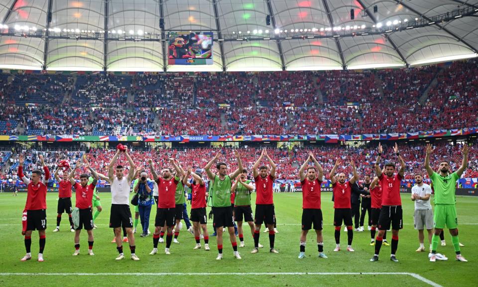 <span>Georgia’s players and fans celebrate their first European Championship point after the draw with Czech Republic on Saturday.</span><span>Photograph: Dan Mullan/Getty Images</span>