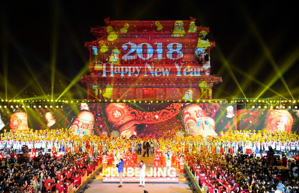 <p>People celebrate the new year during a countdown event at Yongdingmen Gate in Beijing, China, December 31, 2017. (Photo: Jason Lee/Reuters) </p>