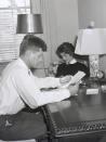 <p>Newlyweds Senator John F. Kennedy and Jackie Kennedy (née Bouvier) are pictured studying together after dinner.</p>