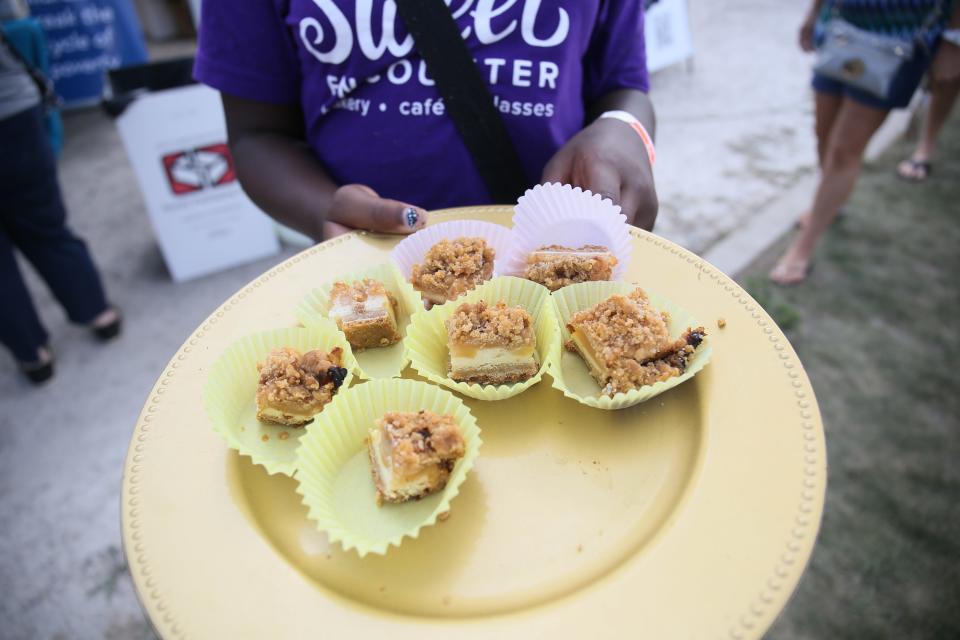 Sweet Encounter Bakery from Lansing, displays various options of their caramel apple cheesecake during the MI New Favorite Snack competition at Vantage Point in Port Huron on Saturday, Sept. 17, 2022.