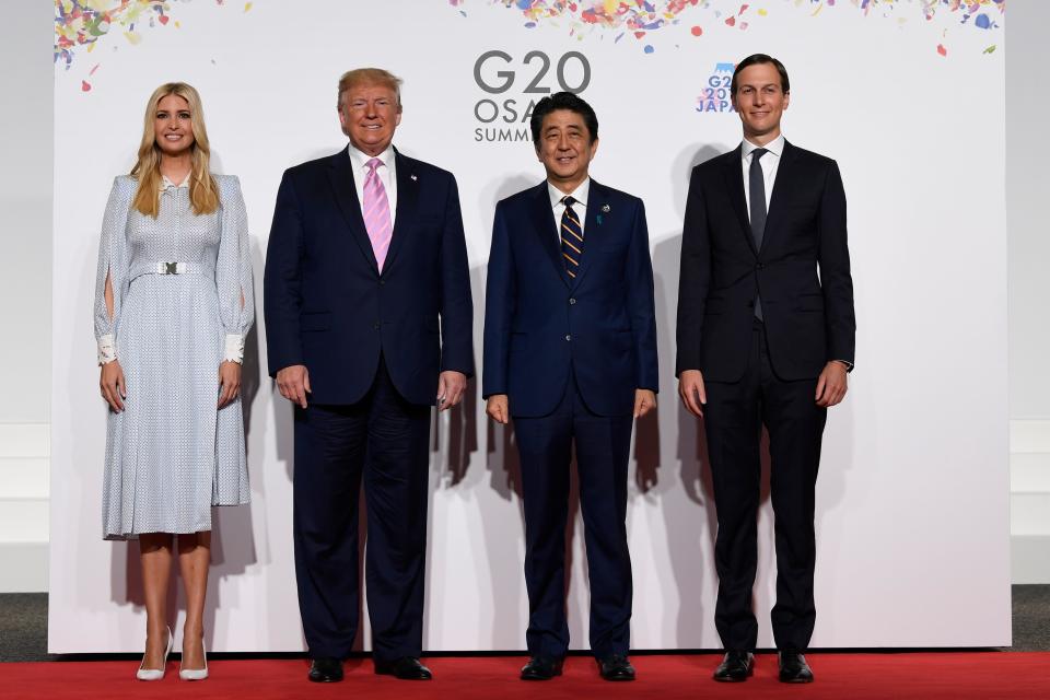 President Donald Trump poses for a photo with Japanese Prime Minister Shinzo Abe and senior advisers Ivanka Trump and Jared Kushner.