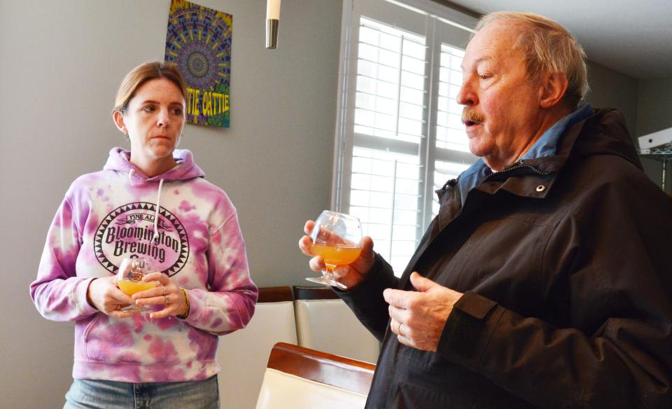 Amanda Frankln, co-owner of Bloomington Brewing Company, talks with Mike Baker on Monday, Nov. 27, 2023, while they sample Indiana Pale Ale, created using the CV12 hops from Baker's Monroe County farm.