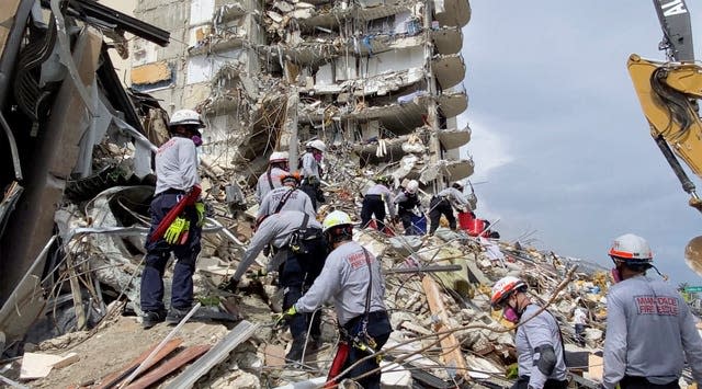 Search and rescue personnel search for survivors through the rubble at the Champlain Towers