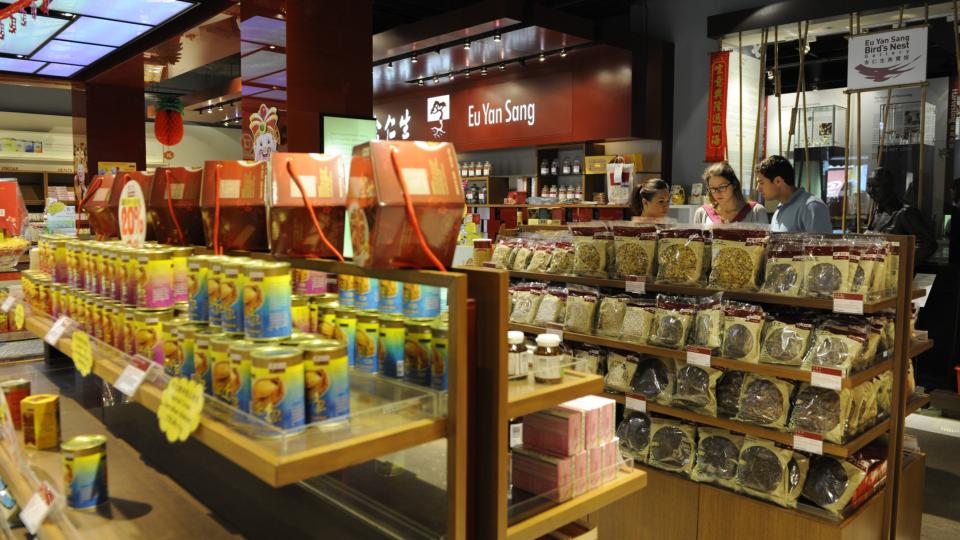 Customers browse traditional Chinese herbal products inside a Eu Yan Sang store in Singapore, on Friday, Feb. 8, 2013.  Photographer: Munshi Ahmed/Bloomberg