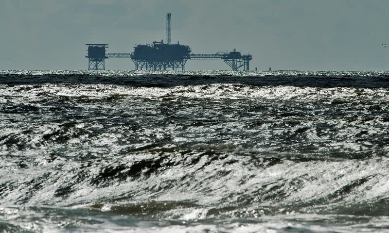 FILE PHOTO: An oil and gas drilling platform stands offshore in Dauphin Island, Alabama