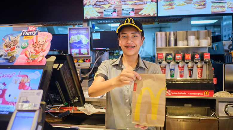 McDonald's employee holding food bag