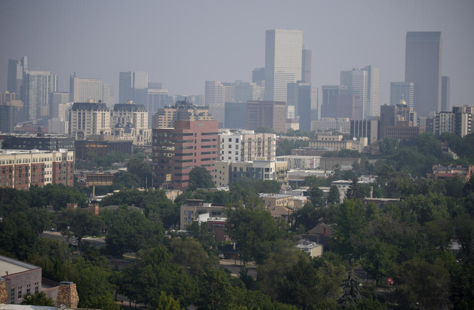 Smoke from western wildfires funnels along Colorado's Front Range and obscures the skyline Sunday, Aug. 8, 2021, in Denver. (AP Photo/David Zalubowski)