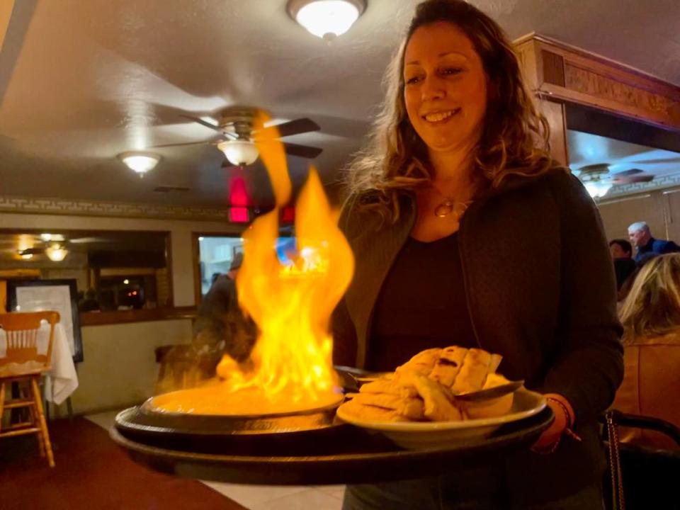 Yianni’s Bar & Grill’s most eye-catching dish is saganaki, flambéed kasseri cheese soaked in brandy and served with pita.