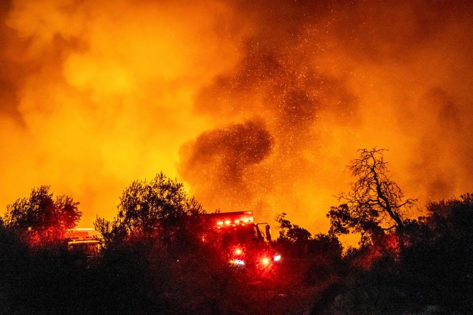 The "Cave Fire" burns a hillside near homes in Santa Barbara, California, early on November 26, 2019. 