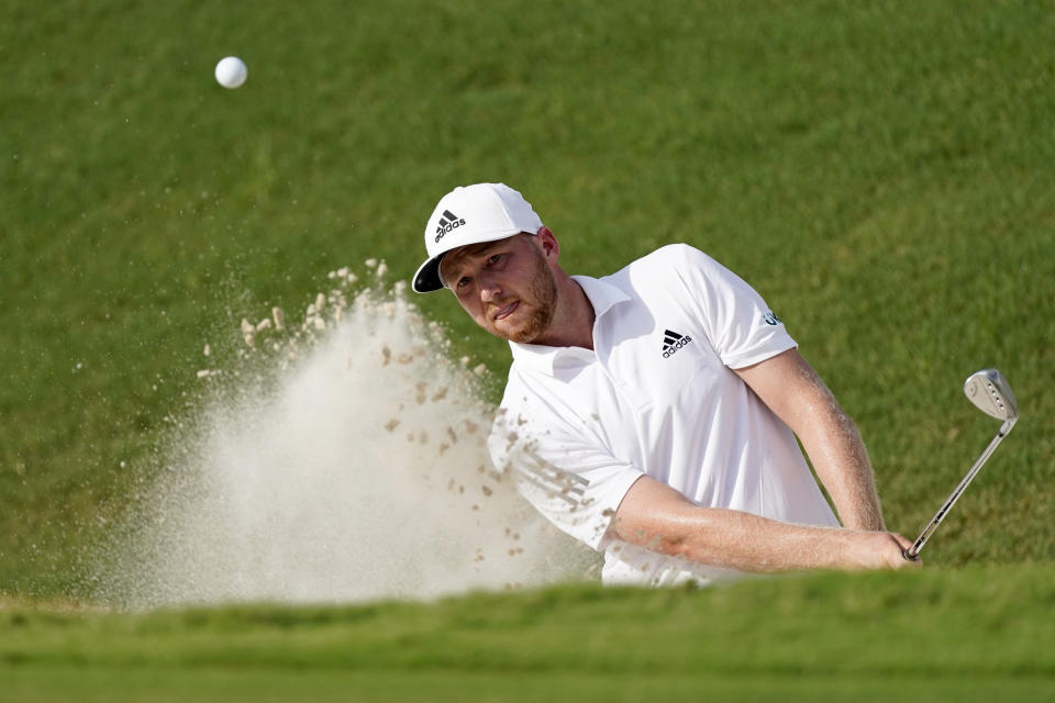 Daniel Berger hits from a greenside bunker on the 18th hole during the first round of play in the Tour Championship golf tournament at East Lake Golf Club, Friday, Sept. 4, 2020, in Atlanta. (AP Photo/John Bazemore)