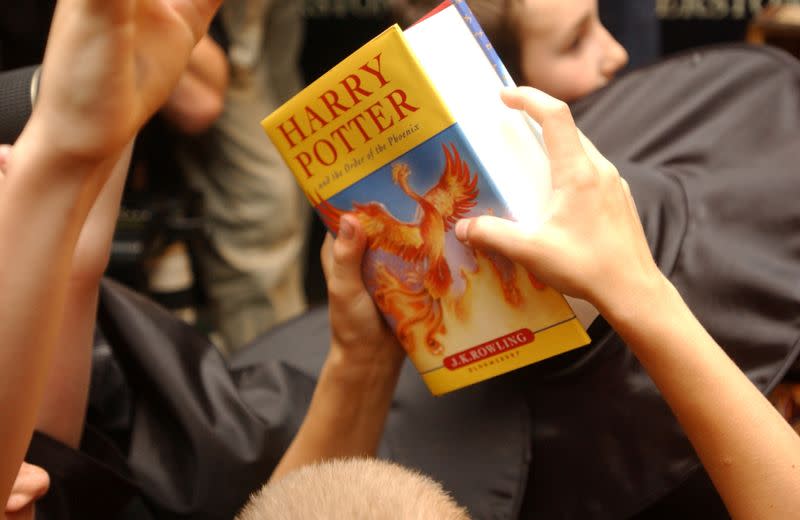 FILE PHOTO: A child holds the latest "Harry Potter" book in London