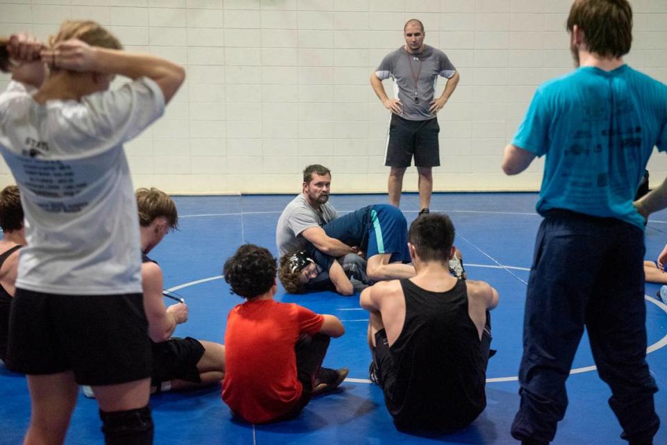 Ocean Springs’ wrestling coach Jay Snow gives a demonstration during Ocean Springs’ high school wrestling practice at E.H. Keys Alternative Education Center on Thursday, Feb. 8, 2024.