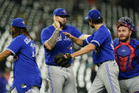 Toronto Blue Jays starting pitcher Alek Manoah, center, celebrates with teammates, from left, Vladimir Guerrero Jr., Jordan Romano and Alejandro Kirk after defeating the Baltimore Orioles in a baseball game, Wednesday, Sept. 7, 2022, in Baltimore. The Blue Jays won 4-1. (AP Photo/Julio Cortez)