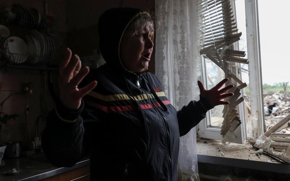 A local resident Olha Lytvynenko, 61, reacts as she stands in her house hit by a Russian military strike, amid Russia's attack on Ukraine - Sofiia Gatilova/REUTERS
