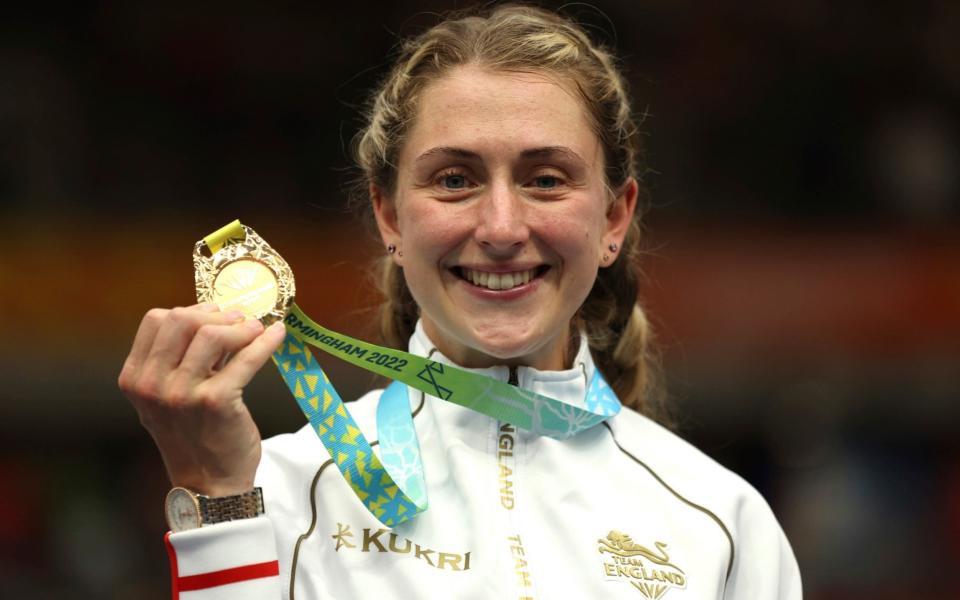 Gold medal winner Laura Kenny of England celebrates on the podium after the women's 10km scratch - AP