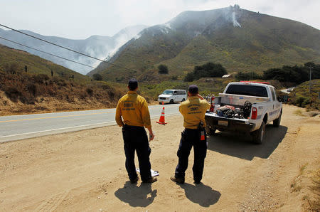 Fire personnel from Santa Barbara County observe activity at Garrapata State Park along State Route 1 during the Soberanes Fire north of Big Sur, California, U.S. July 30, 2016. REUTERS/Michael Fiala