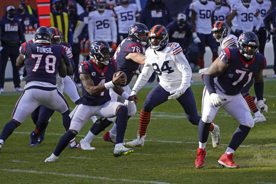 Houston Texans quarterback Deshaun Watson (4) is pressured by Chicago Bears' Robert Quinn (94) during the first half of an NFL football game, Sunday, Dec. 13, 2020, in Chicago. (AP Photo/Charles Rex Arbogast)