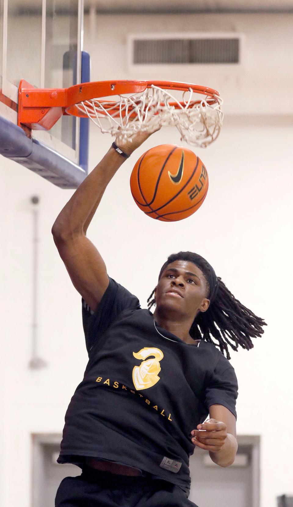 College Achieve's David Munro, a Neptune resident, dunks the ball during practice Monday afternoon.