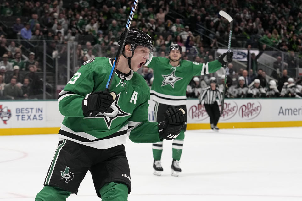 Dallas Stars defenseman Esa Lindell, left, celebrates after scoring against the Arizona Coyotes in the first period of an NHL hockey game, Tuesday, Nov. 14, 2023, in Dallas. (AP Photo/Tony Gutierrez)