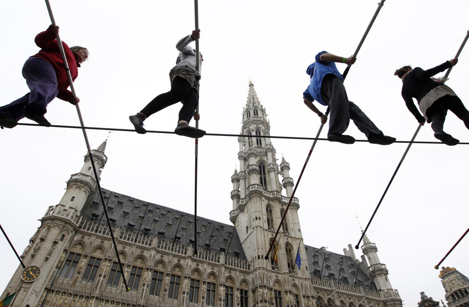 Tightrope walkers perform on Brussels's Grand Place during an event marking the 30th birthday of the circus school of Brussels November 6, 2011. REUTERS/Francois Lenoir