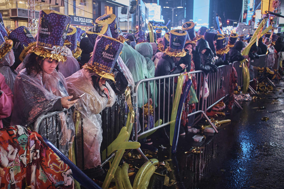 Revelers gather under the rain as they wait for the countdown during the New Year's Eve celebrations in Times Square, late Saturday, Dec. 31, 2022, in New York. (AP Photo/Andres Kudacki)