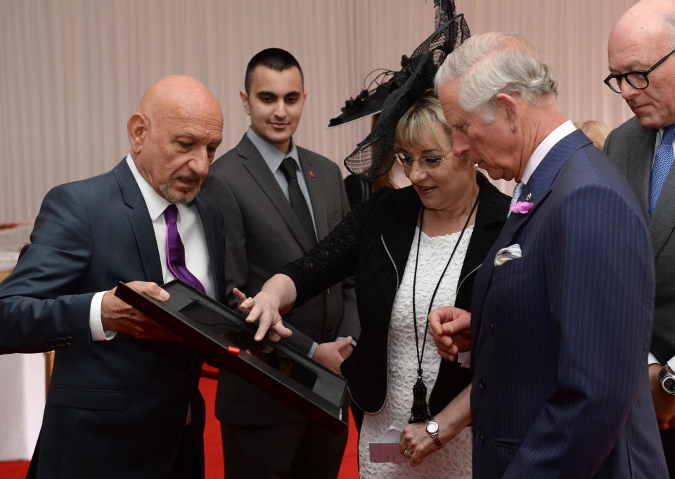 Prince Charles, Prince of Wales meets Sir Ben Kingsley (L) and Martina Milburn, chief executive of the Prince's Trust (2nd, R) and is presented with a Digital Book of Memories, containing messages recorded by young people and supporters of The Princes Trust, during a garden party to mark the 40th anniversary of the Prince's Trust at Buckingham Palace on May 17, 2016 in London, England. The garden party is held in honour of the 5,000 supporters and beneficiaries of The Prince's Trust. (Photo by Anthony Devlin/WPA Pool/Getty Images)