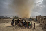 <p>Huth, Amran Governorate, Yemen, april 25, 2017: Children watch a mini tornado whip up sand as it travels across the desert landscape near the town of Huth situated about 80km north of Yemen’s capital of Sanaa. (Photograph by Giles Clarke for UN OCHA/Getty Images) </p>