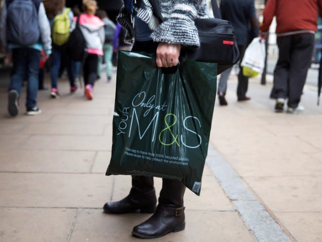 FILE PHOTO: A shopper carries a Marks and Spencer bag in central London, Britain, May 20, 2015. REUTERS/Neil Hall/File Photo