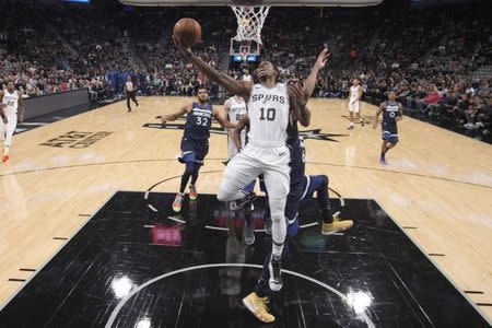 Oct 17, 2018; San Antonio, TX, USA; San Antonio Spurs shooting guard DeMar DeRozan (10) shoots the ball past Minnesota Timberwolves power forward Taj Gibson (67) during the first half at AT&T Center. Mandatory Credit: Soobum Im-USA TODAY Sports