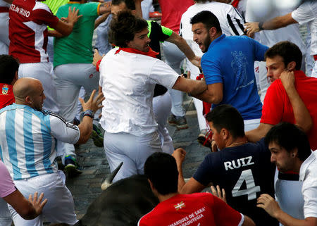 Sergio Colas runs ahead of the bulls during a crowded run at the San Fermin festival in Pamplona, northern Spain, July 8, 2016. REUTERS/Susana Vera