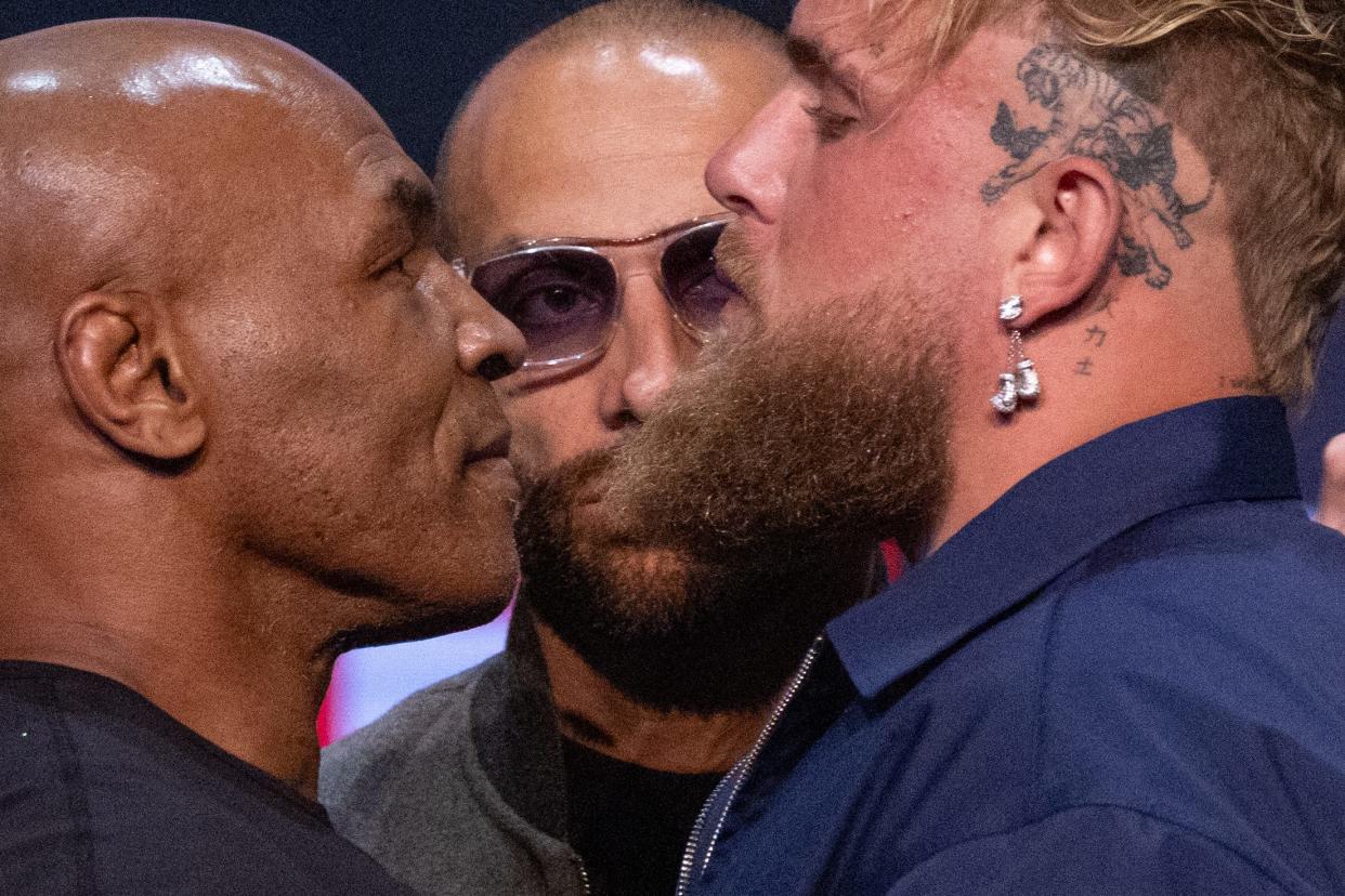 Former US boxer Mike Tyson (L) and YouTuber Jake Paul face off during a press conference at the Apollo Theatre in New York, on May 13, 2024. Former heavyweight boxing champion Mike Tyson's July 20 fight against YouTube sensation Jake Paul in Dallas will be a sanctioned heavyweight professional bout, fighters and promoters announced on April 29. The fight will be over eight two-minute rounds with the result to count on the record of both Paul and Tyson, who lost his last official bout in 2005. (Photo by Kena Betancur / AFP) (Photo by KENA BETANCUR/AFP via Getty Images)