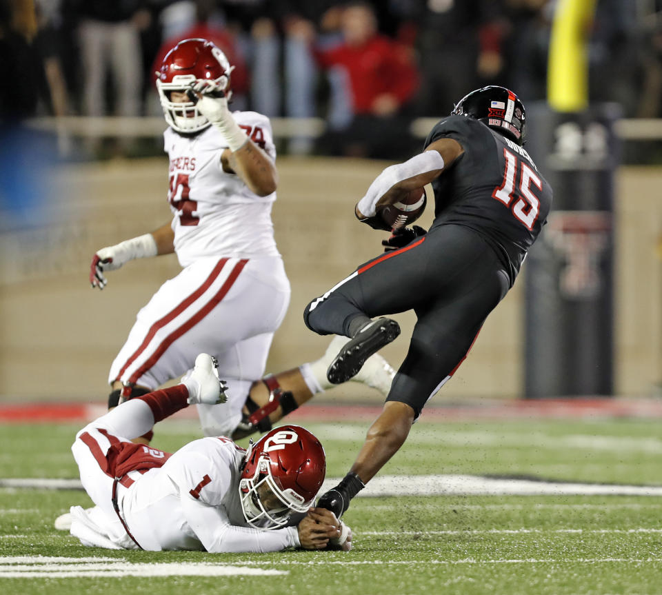 Texas Tech's Vaughnte Dorsey (15) breaks a tackle by Kyler Murray (1) after intercepting his pass during the first half of an NCAA college football game Saturday, Nov. 3, 2018, in Lubbock, Texas. (AP Photo/Brad Tollefson)
