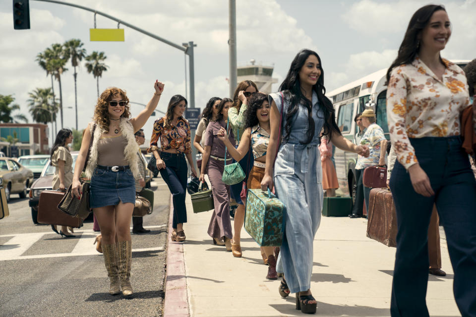 Isabel (Paulina Dávila) waves as she walks toward Griselda waiting with her Sprinter van.<span class="copyright">Elizabeth Morris—Netflix</span>