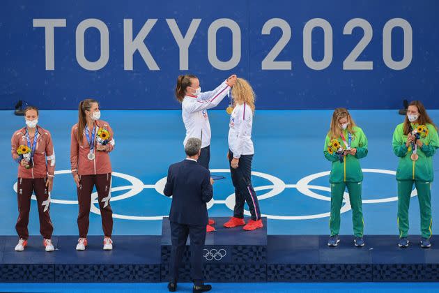 The Czech Republic's Barbora Krejcikova, center, places a medal on teammate Katerina Siniakova. The pair won gold in women's doubles tennis on Aug. 1. (Photo: VINCENZO PINTO via Getty Images)