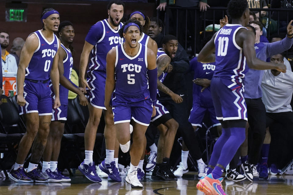 TCU forward Chuck O'Bannon Jr. (5) celebrates in front of the bench after scoring the final basket of the team's NCAA college basketball game against Baylor in Waco, Texas, Wednesday, Jan. 4, 2023. TCU won 88-87. (AP Photo/LM Otero)